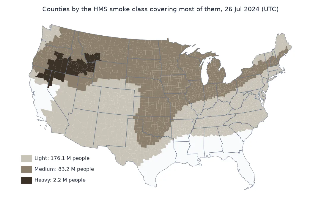 Map of the contiguous United States with counties coloured by the HMS smoke class covering most of each on 26 July 2024: heavy smoke over Idaho, eastern Oregon and northern Nevada; medium smoke across the northern tier from Washington to New England and down through the Plains; light smoke over most of the South and West; California's coast and the Gulf Coast states largely clear.